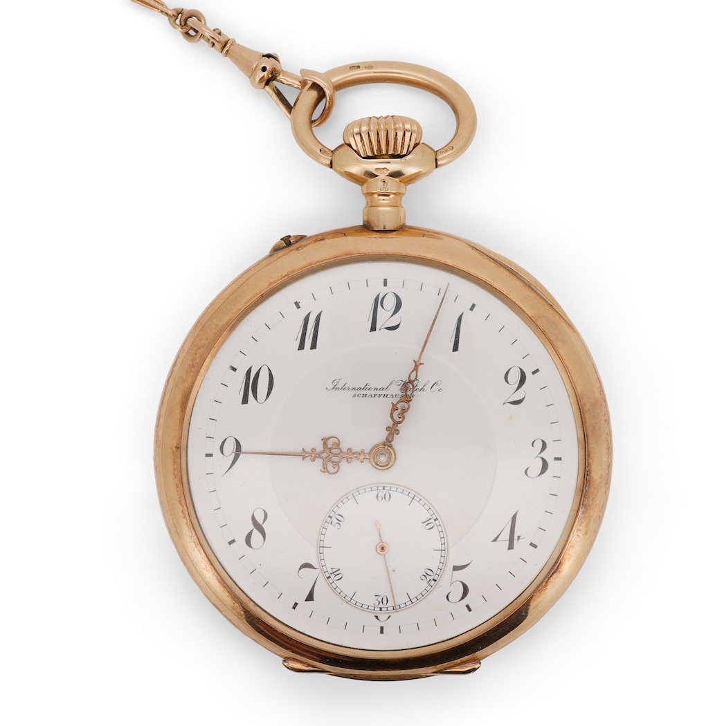 An early 20th century International Watch Company engine turned 14k yellow metal open faced keyless lever pocket watch, together with a Viennese? two colour yellow metal albert, maker's mark, LE